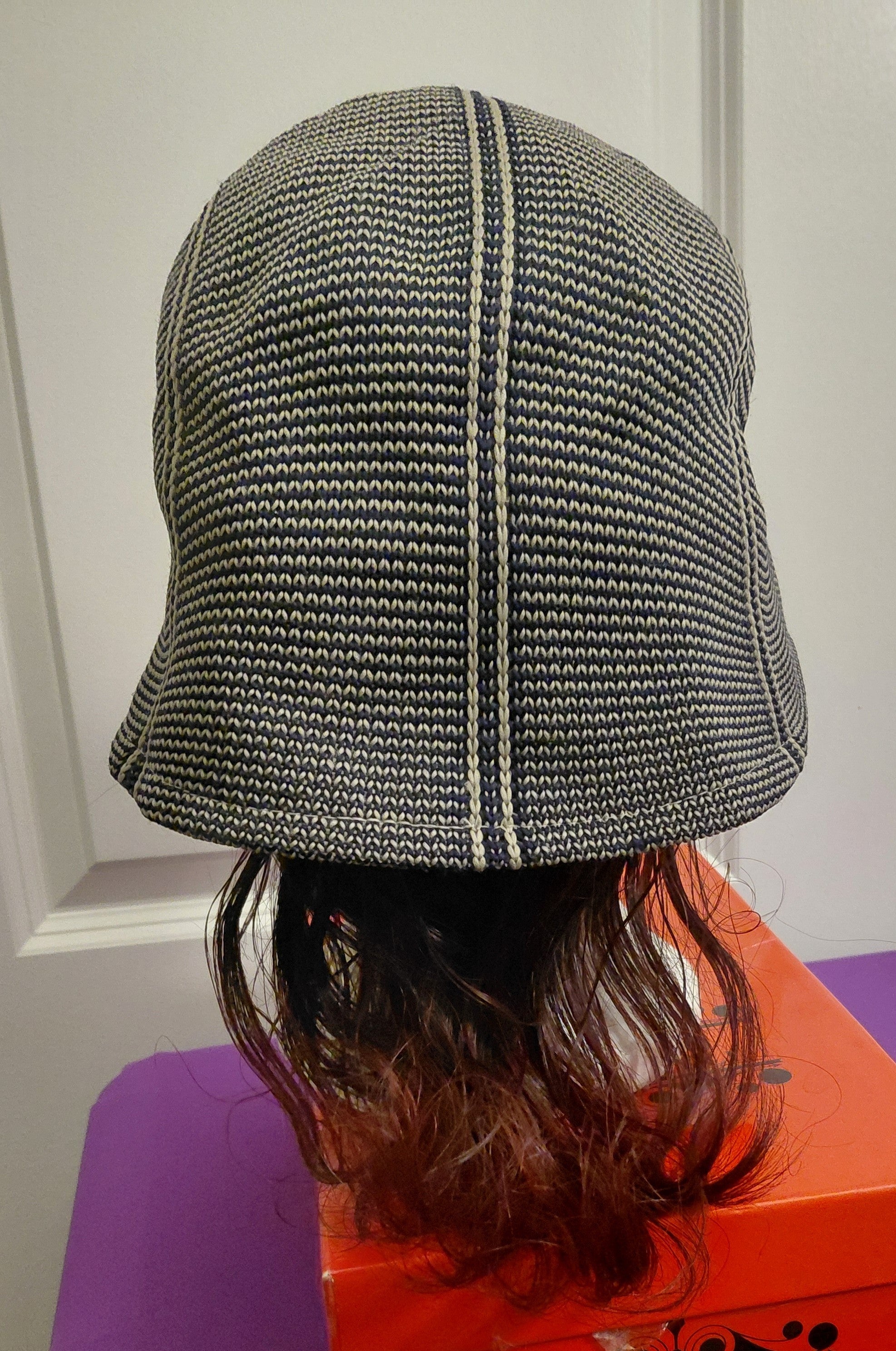 Black and White hat with Bergundy and black hair