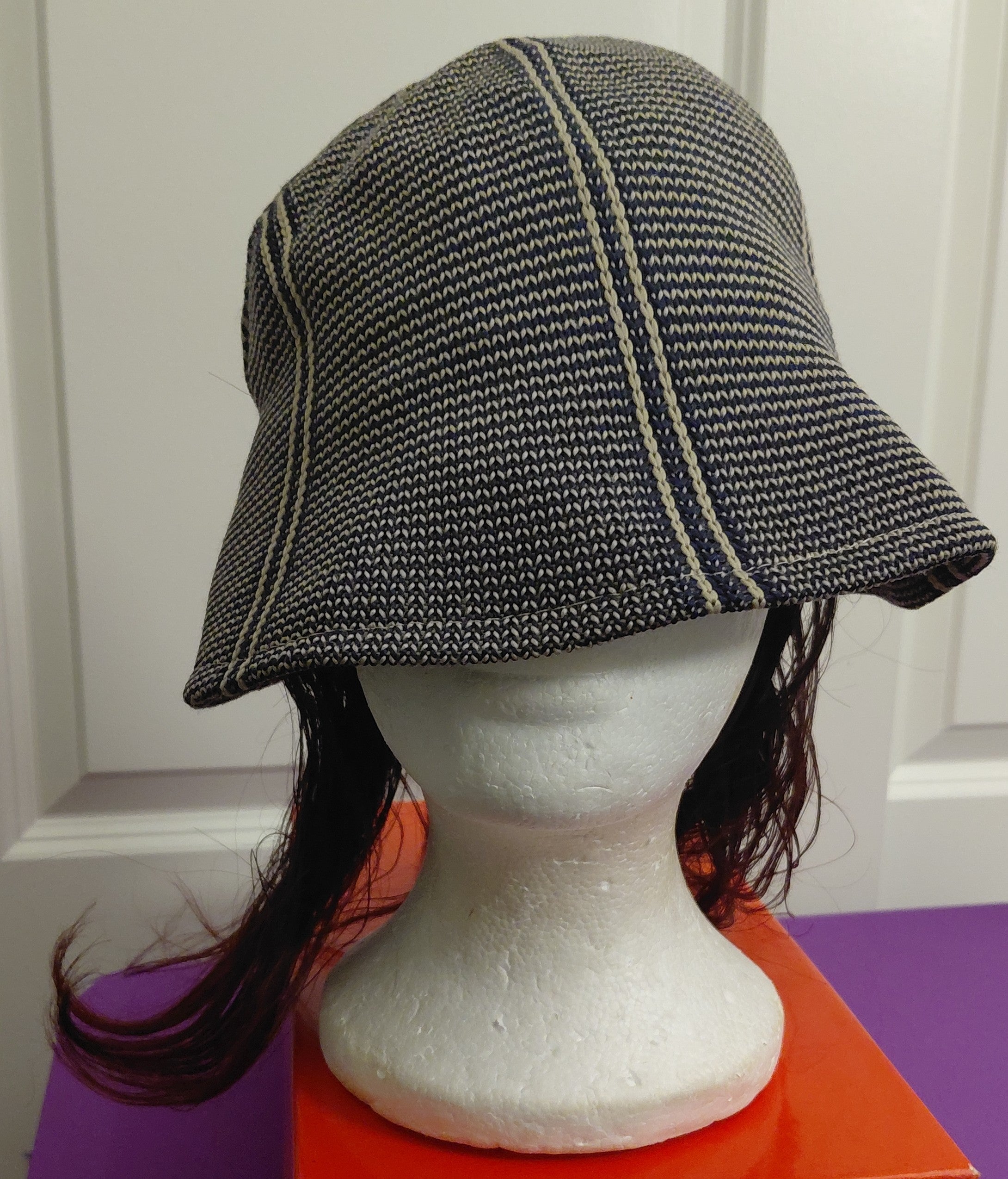 Black and White hat with Bergundy and black hair